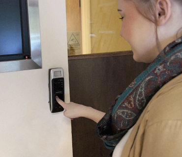 Female employee using hand scanner terminal